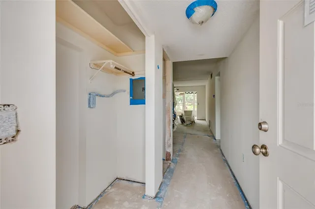 a view of a hallway with a livingroom and a bathroom with a sink