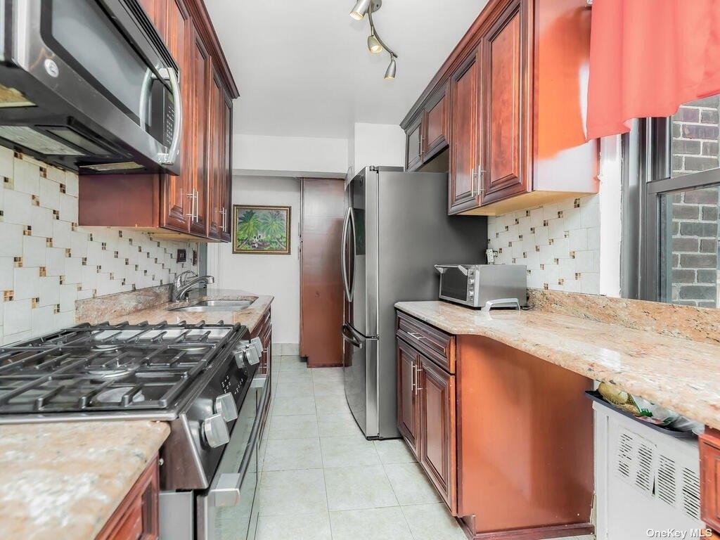 2835 Webb Avenue, Unit 7E Bronx, NY 10468 - Photo 13 of 24 a kitchen with stainless steel appliances granite countertop a stove top oven a sink a refrigerator and dishwasher