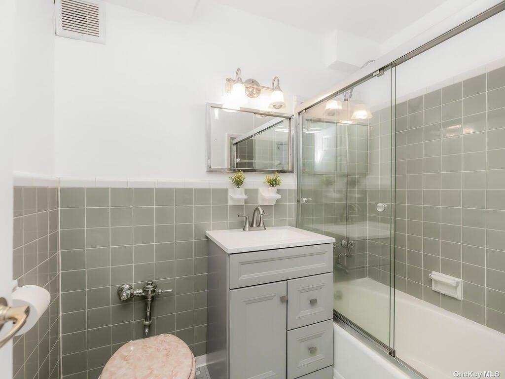 2835 Webb Avenue, Unit 7E Bronx, NY 10468 - Photo 17 of 24 a bathroom with a sink mirror toilet and shower