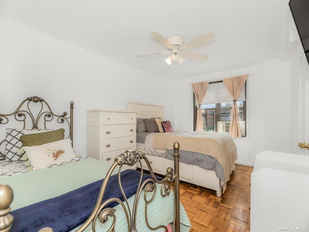 2835 Webb Avenue, Unit 7E Bronx, NY 10468 - Photo 20 of 24 a bedroom with a bed and a chandelier