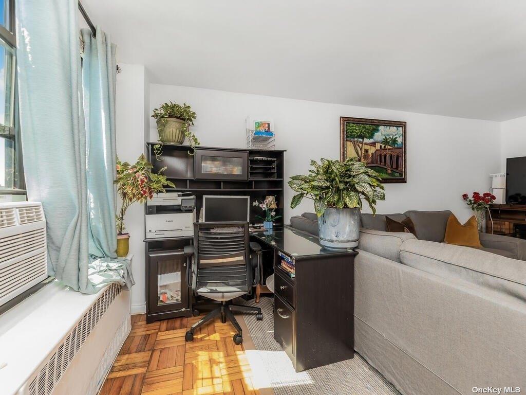2835 Webb Avenue, Unit 7E Bronx, NY 10468 - Photo 9 of 24 a living room with furniture and a potted plant