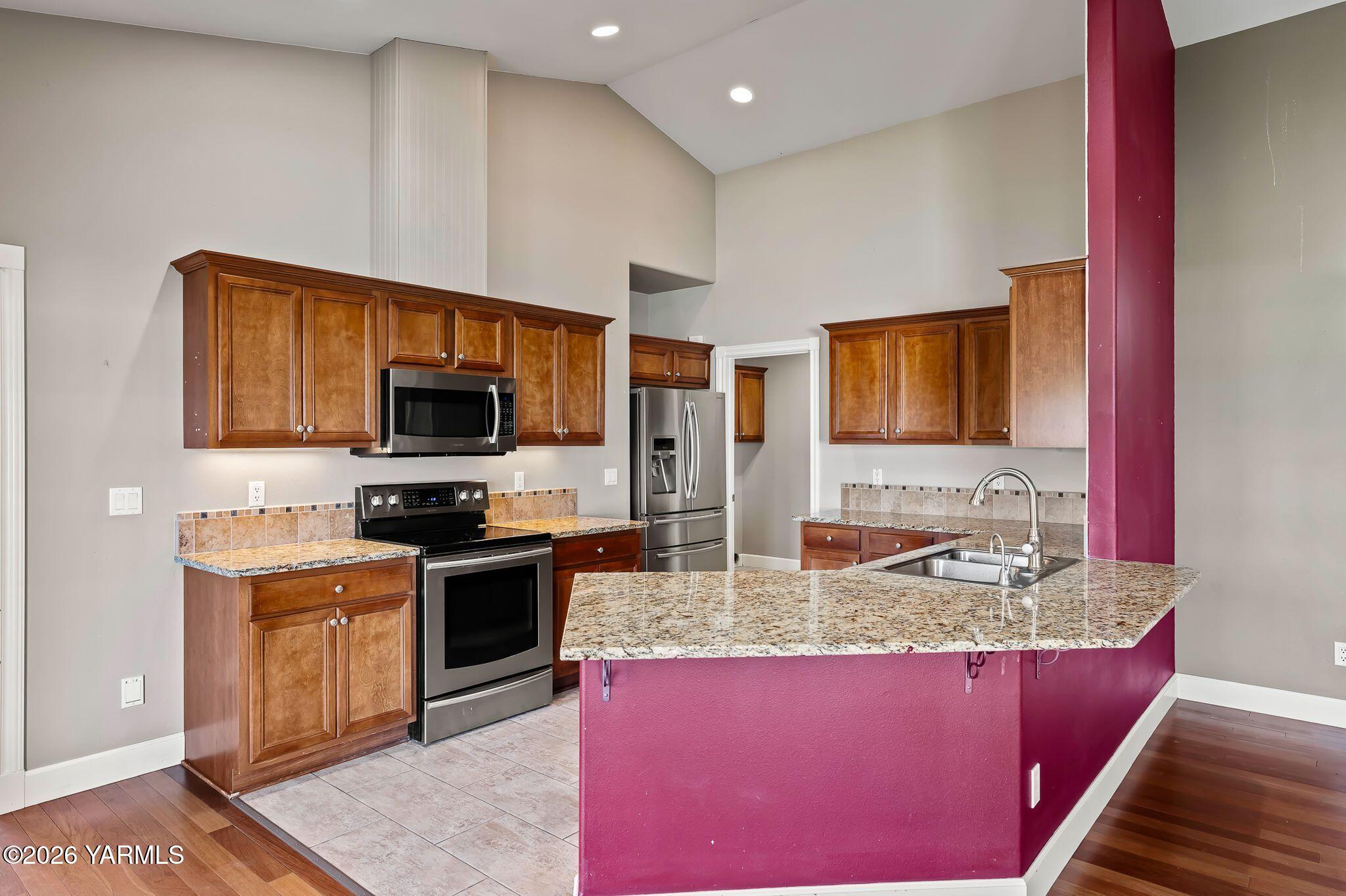 8507 Midvale Road Yakima, WA 98908 - Photo 8 of 24 a kitchen with stainless steel appliances granite countertop a sink stove microwave and refrigerator