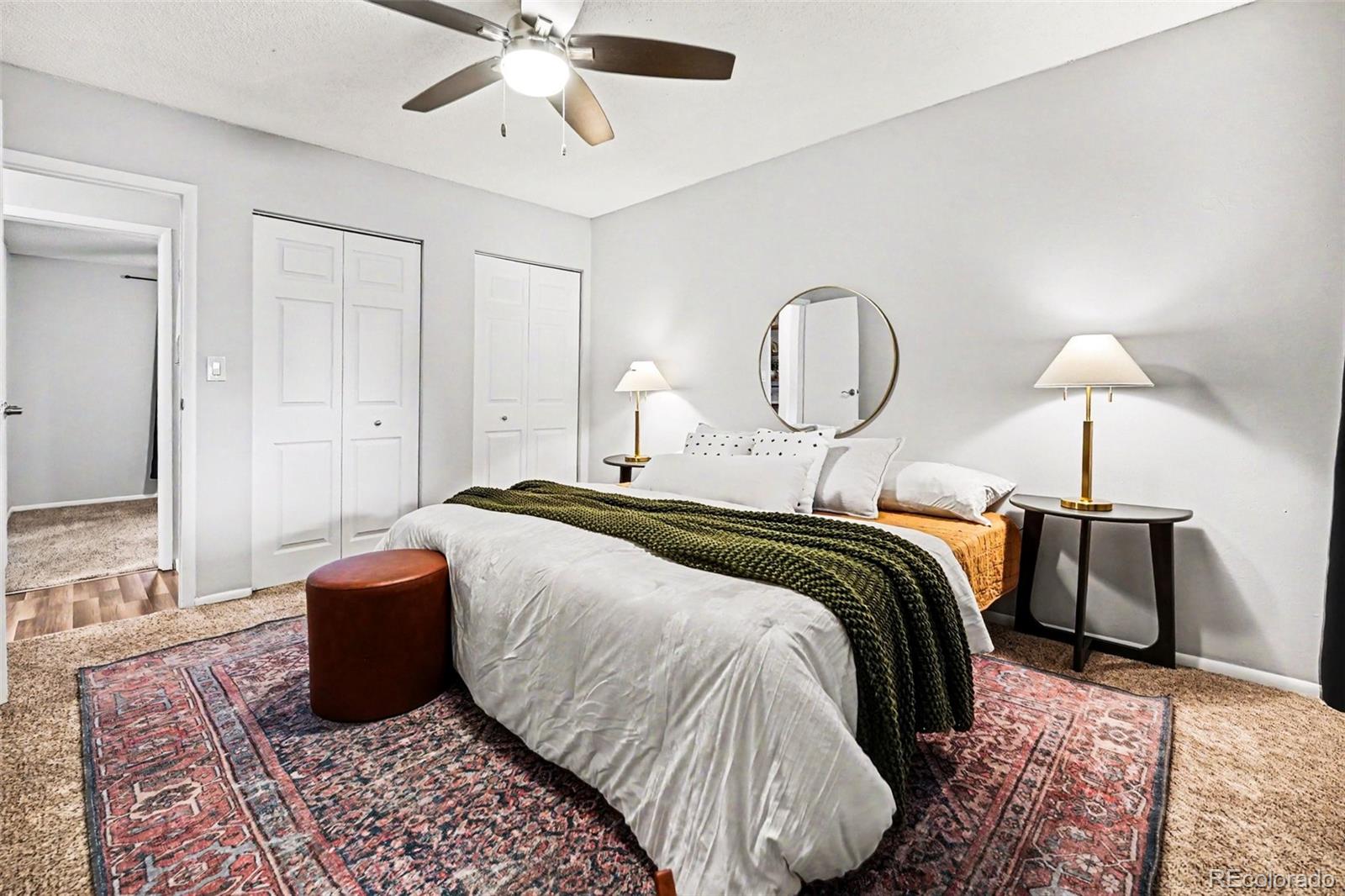 5700 West 28th Avenue, Unit 1 Wheat Ridge, CO 80214 - Photo 11 of 25 a bedroom with a bed and lamps