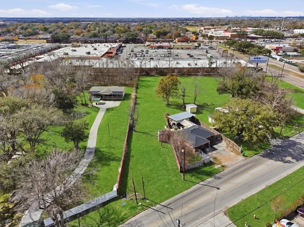 an aerial view of a house with a yard and lake view