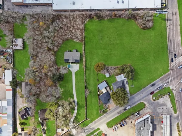an aerial view of a house with a yard basket ball court and outdoor seating