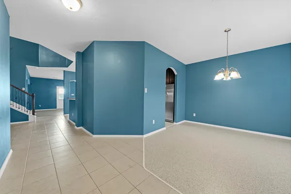a view of a livingroom with furniture and an entryway