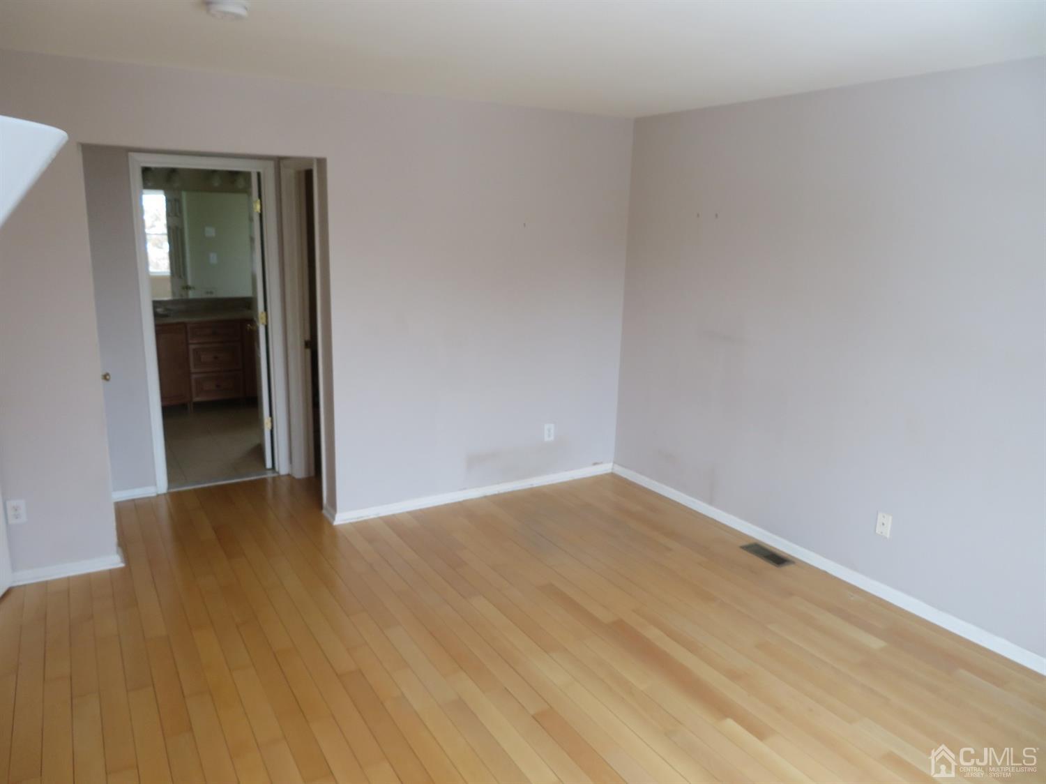 55 Devon Drive East Brunswick, NJ 08816 - Photo 12 of 28 a view of an empty room with wooden floor and a bathroom