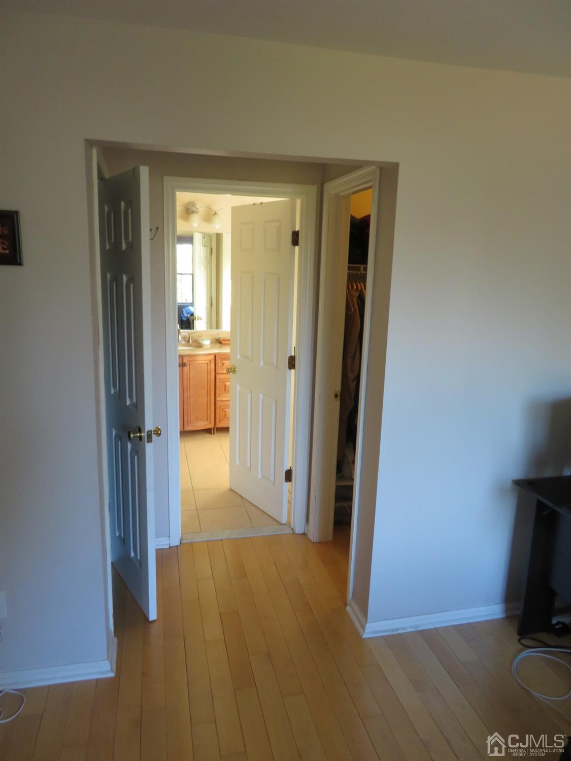 55 Devon Drive East Brunswick, NJ 08816 - Photo 14 of 28 a view of a hallway with wooden floor and a living room