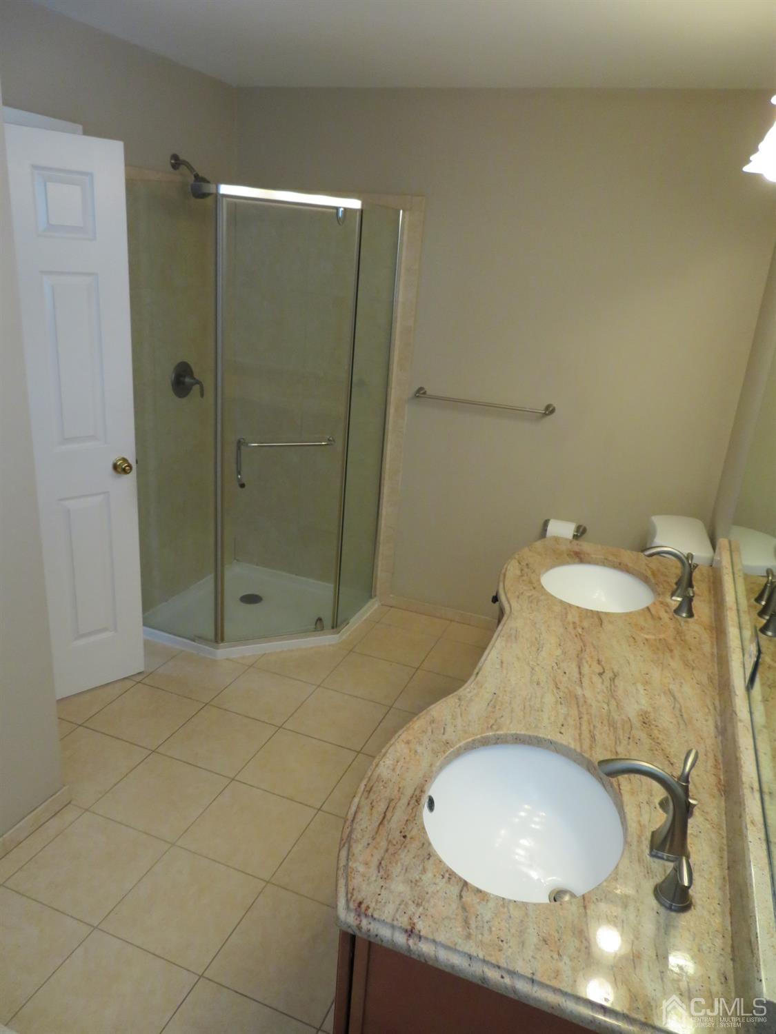 55 Devon Drive East Brunswick, NJ 08816 - Photo 16 of 28 a bathroom with a granite countertop sink and a mirror