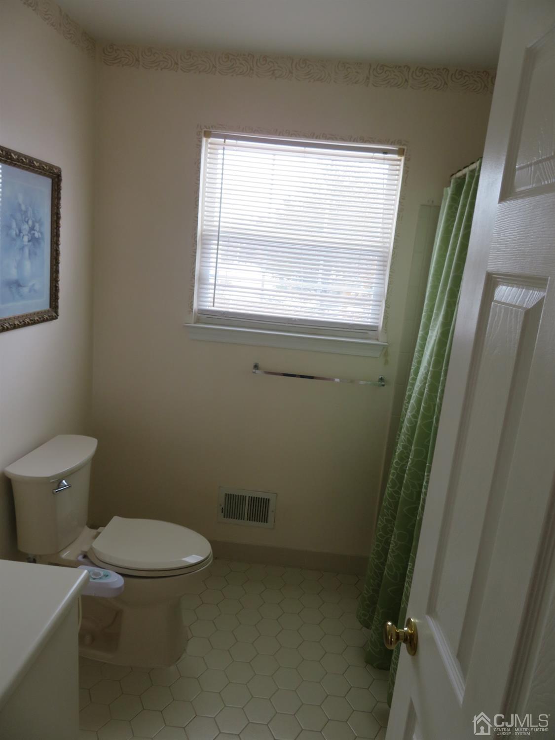 55 Devon Drive East Brunswick, NJ 08816 - Photo 18 of 28 a white toilet sitting next to a window in a bathroom