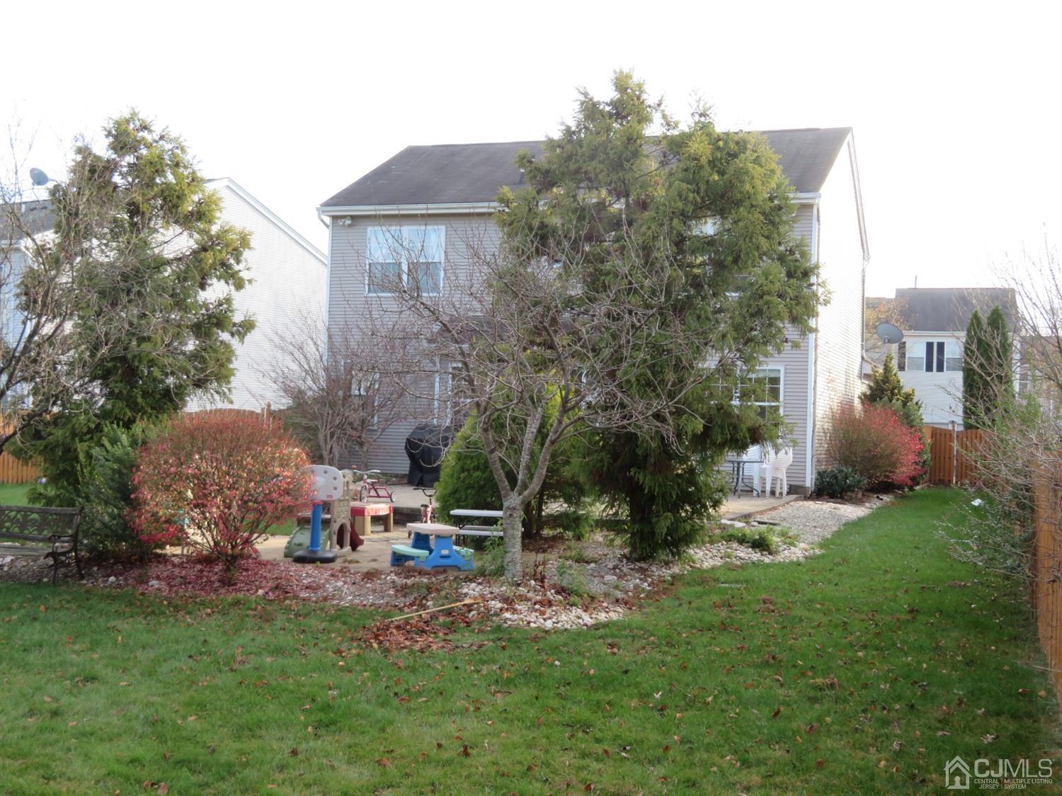 55 Devon Drive East Brunswick, NJ 08816 - Photo 23 of 28 a backyard of a house with table and chairs