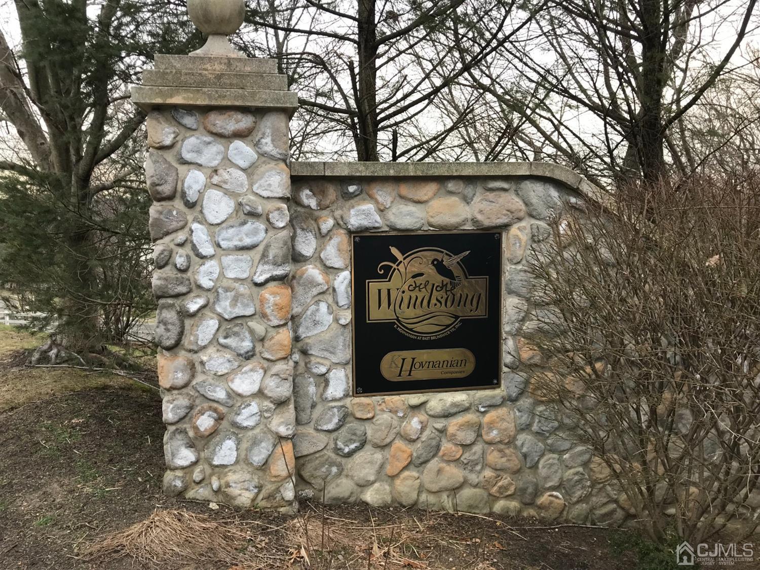 55 Devon Drive East Brunswick, NJ 08816 - Photo 28 of 28 a wall with a wall clock and a tree
