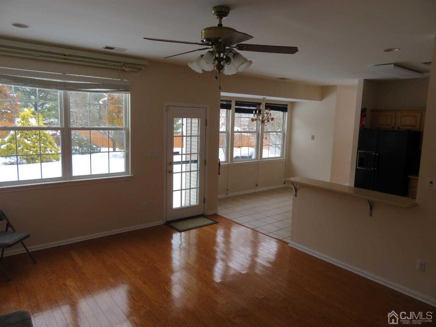 55 Devon Drive East Brunswick, NJ 08816 - Photo 8 of 28 a view of an empty room with a window and wooden floor