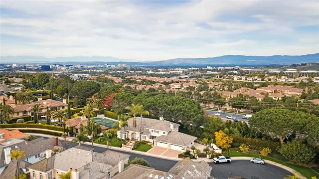 a aerial view of a house next to a yard