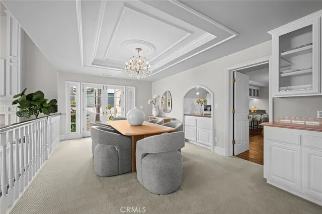 a kitchen with stainless steel appliances granite countertop a refrigerator a sink and white cabinets