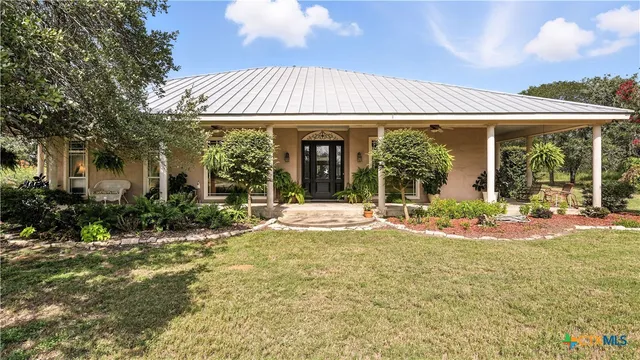 a view of a house with backyard and porch