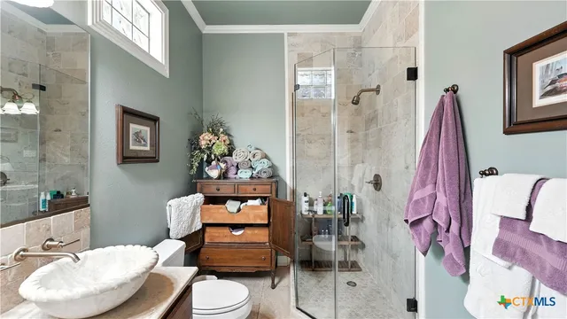 a view of a dining room with furniture a chandelier and wooden floor