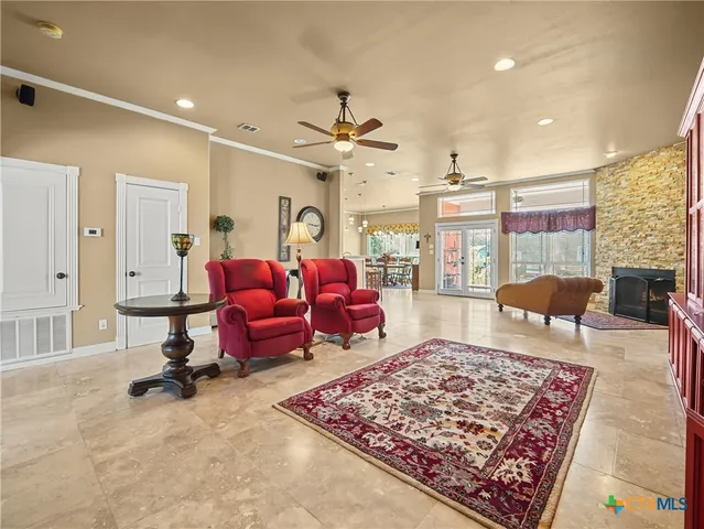 a kitchen with stainless steel appliances granite countertop a sink a stove and a wooden cabinets