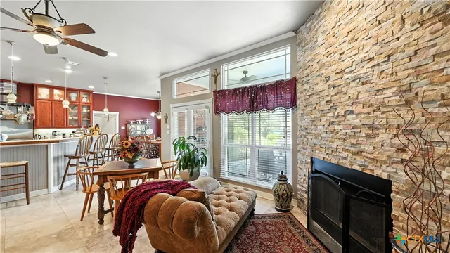 a kitchen with stainless steel appliances granite countertop a sink a stove and a wooden cabinets