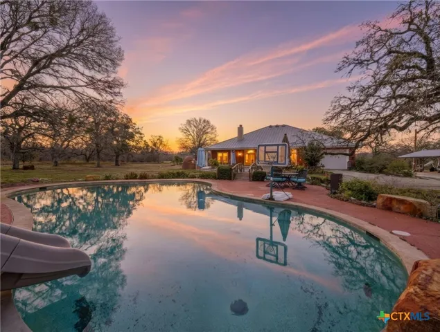a view of swimming pool with a lake view
