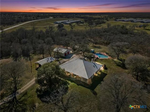 a view of a house with a yard and mountain view