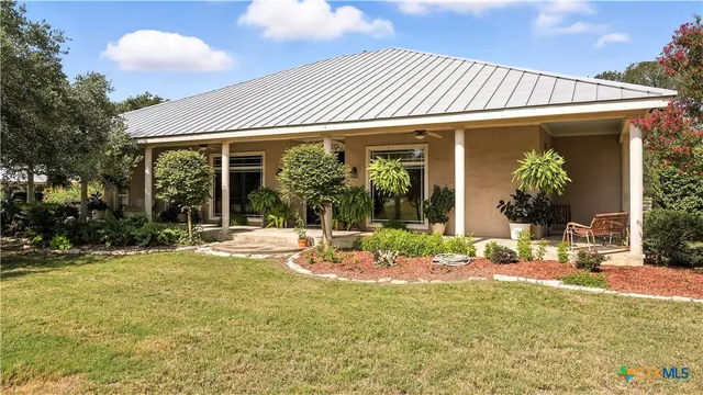 a backyard of a house with yard barbeque oven and outdoor seating