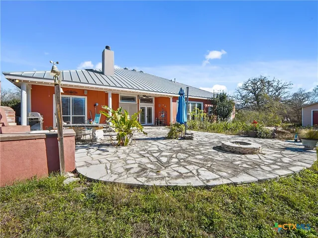 a living room with dining table and paintings on the wall