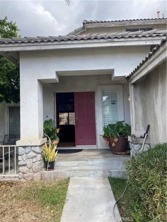 a front view of a house with outdoor seating