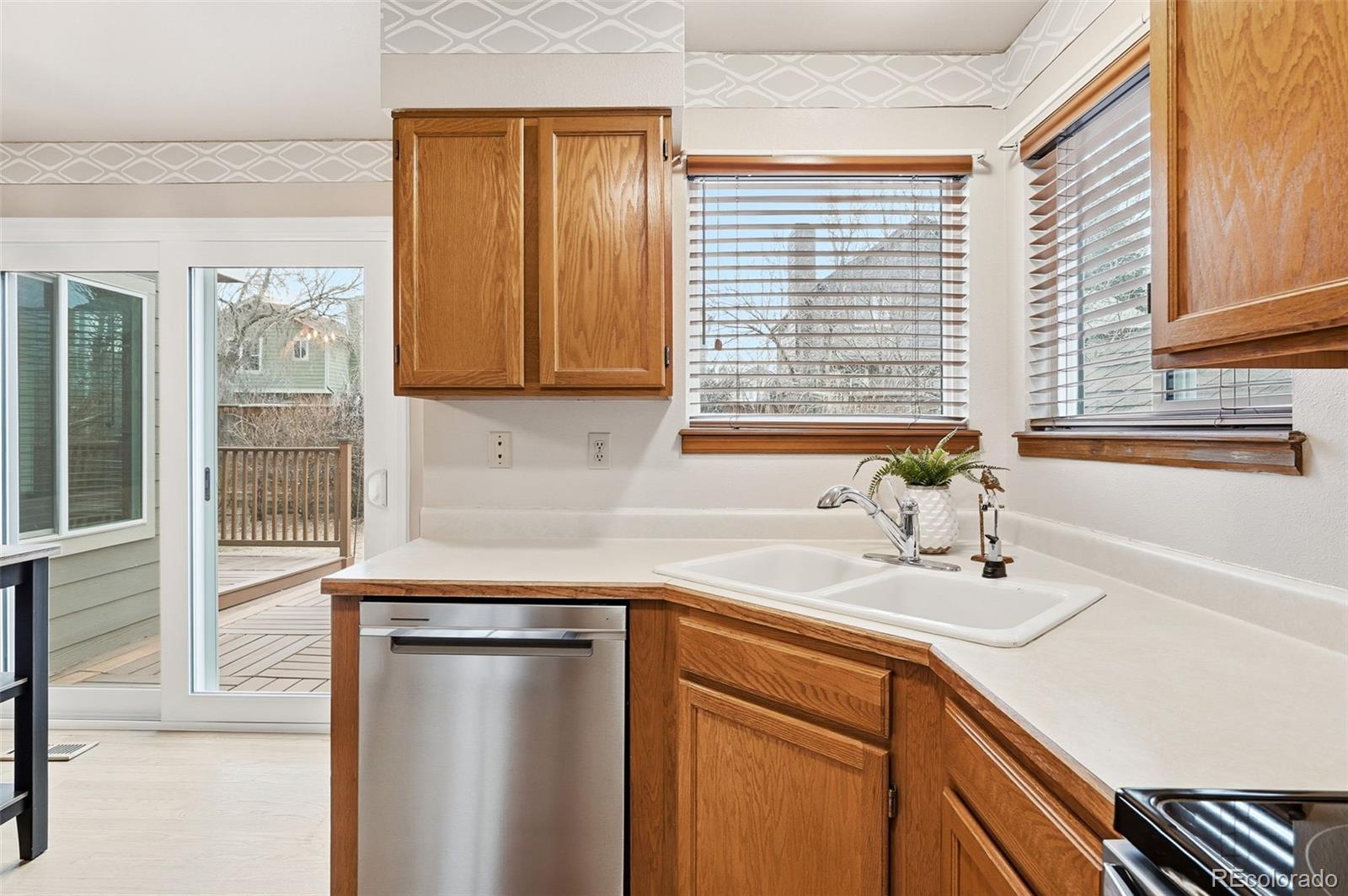 8362 Sunnyside Place Highlands Ranch, CO 80126 - Photo 15 of 50 a kitchen with a sink cabinets and a window