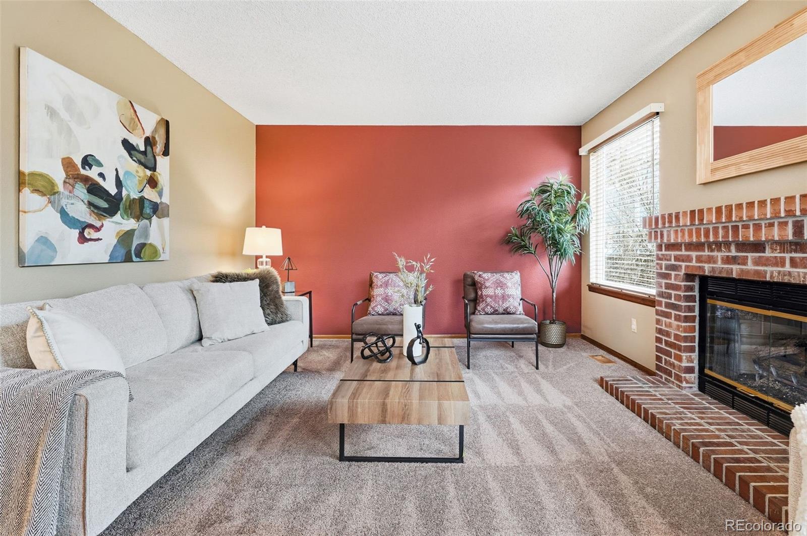 8362 Sunnyside Place Highlands Ranch, CO 80126 - Photo 18 of 50 a living room with furniture a window and a fireplace