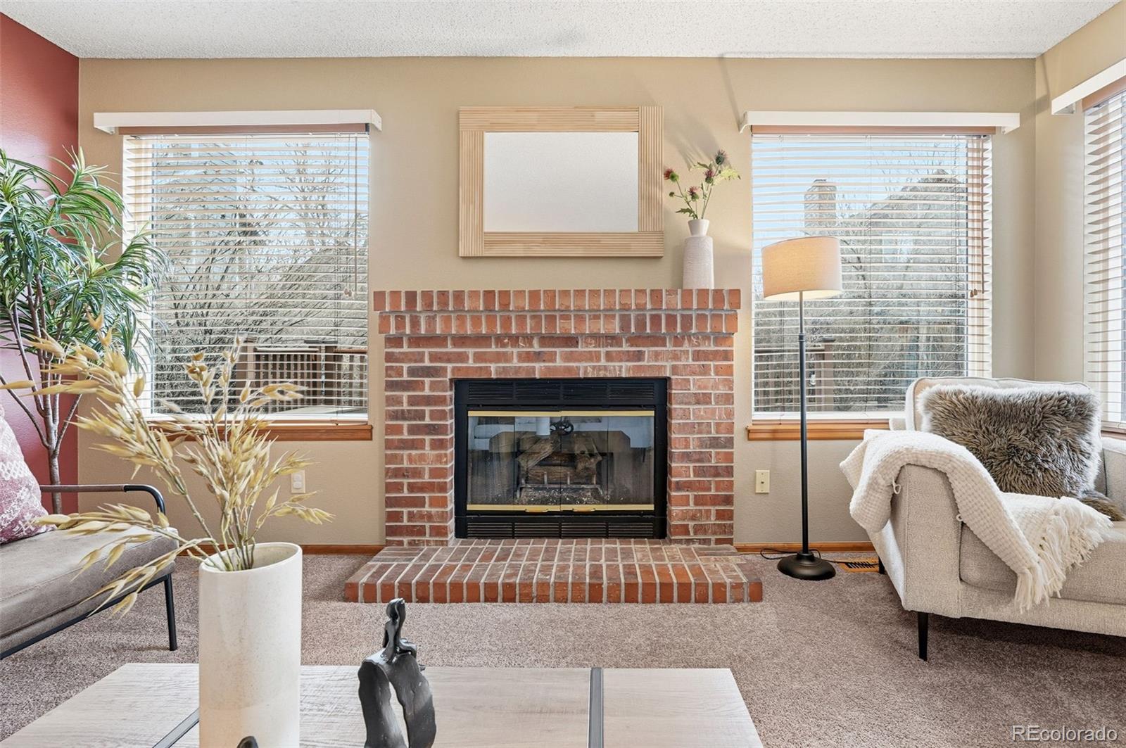 8362 Sunnyside Place Highlands Ranch, CO 80126 - Photo 20 of 50 a living room with furniture and a fireplace