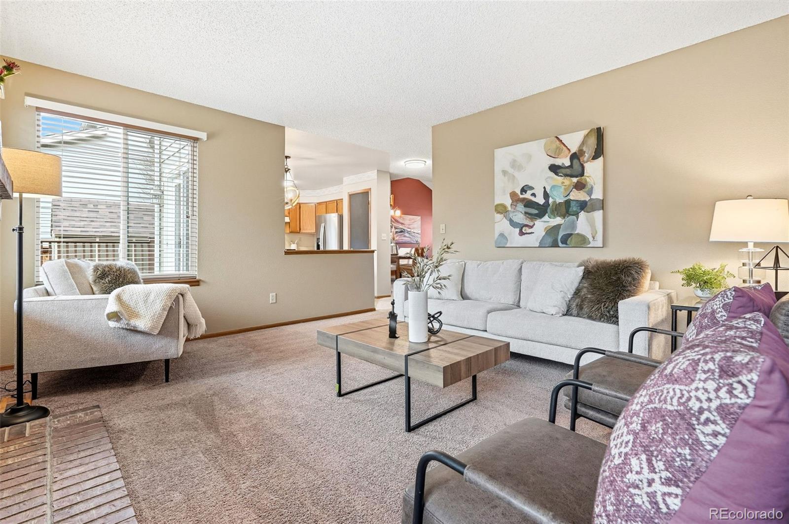 8362 Sunnyside Place Highlands Ranch, CO 80126 - Photo 21 of 50 a living room with furniture and a large window with wooden floor