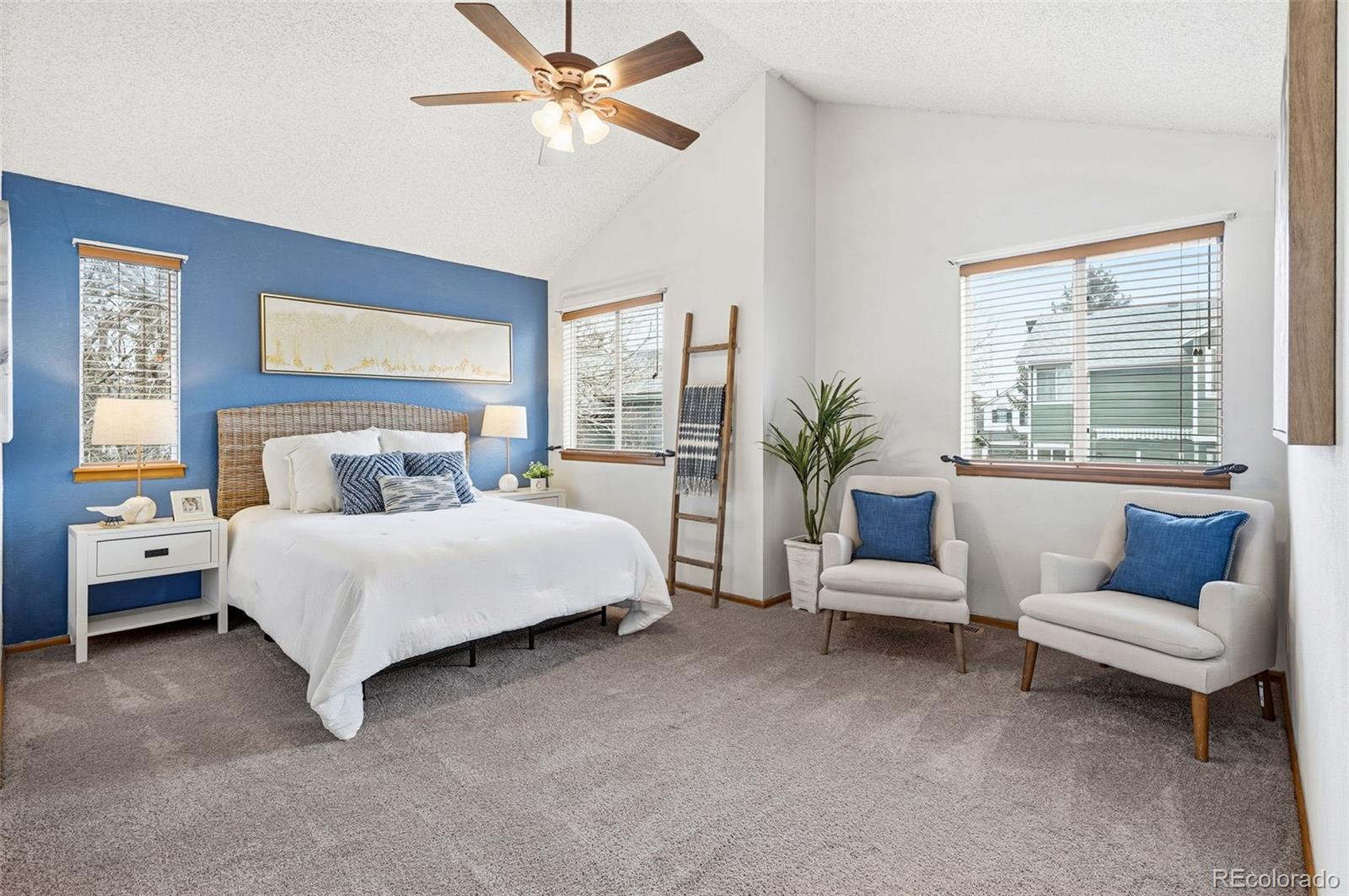8362 Sunnyside Place Highlands Ranch, CO 80126 - Photo 24 of 50 a bedroom with a bed a couch and potted plant