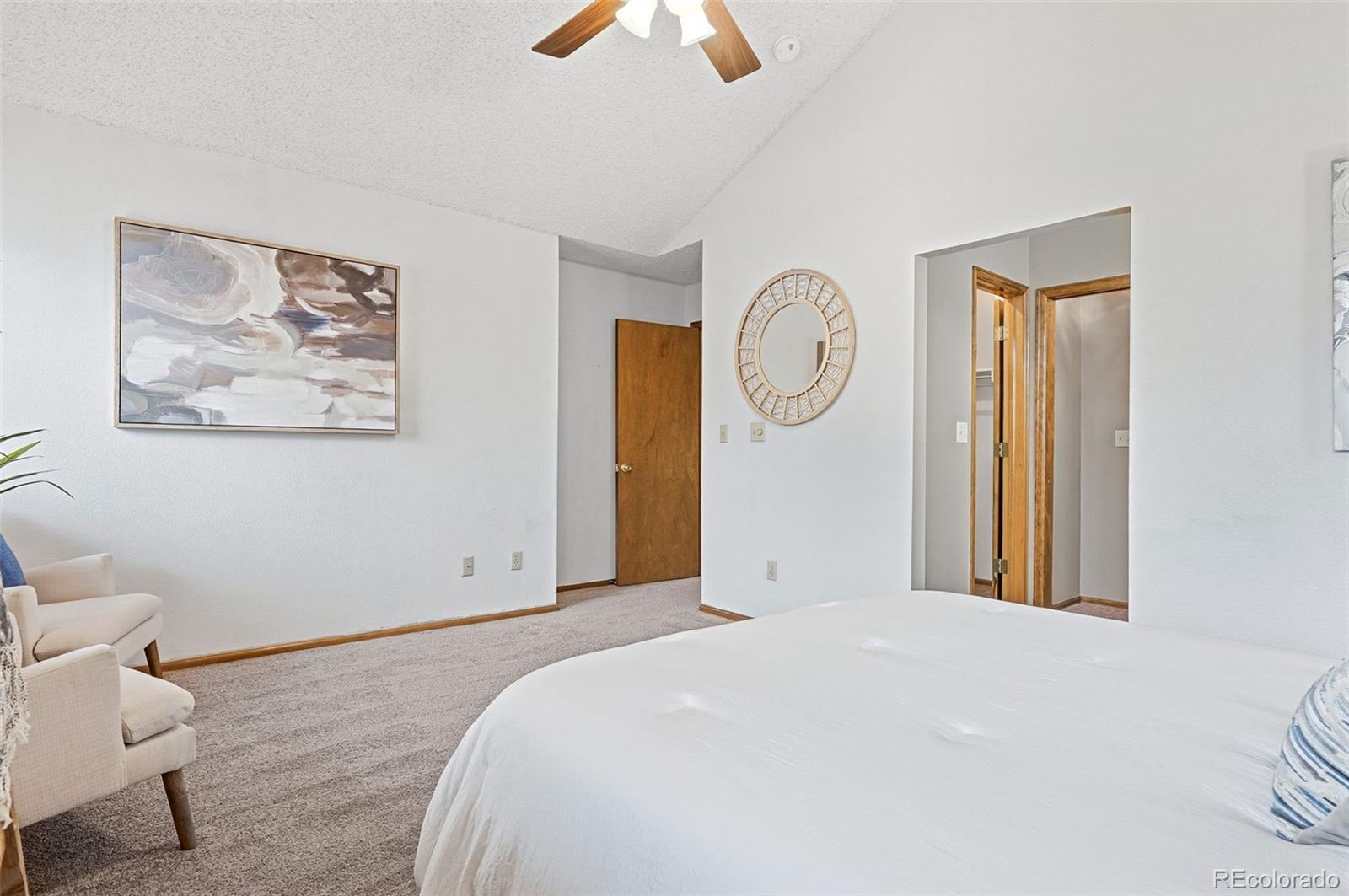 8362 Sunnyside Place Highlands Ranch, CO 80126 - Photo 28 of 50 a bedroom with a bed and a chandelier