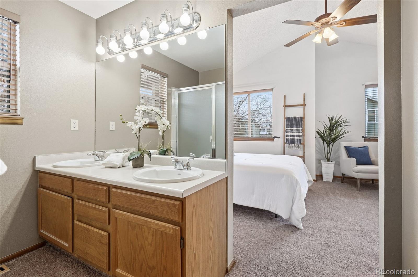 8362 Sunnyside Place Highlands Ranch, CO 80126 - Photo 30 of 50 a spacious en suite bathroom with a double sink and a mirror