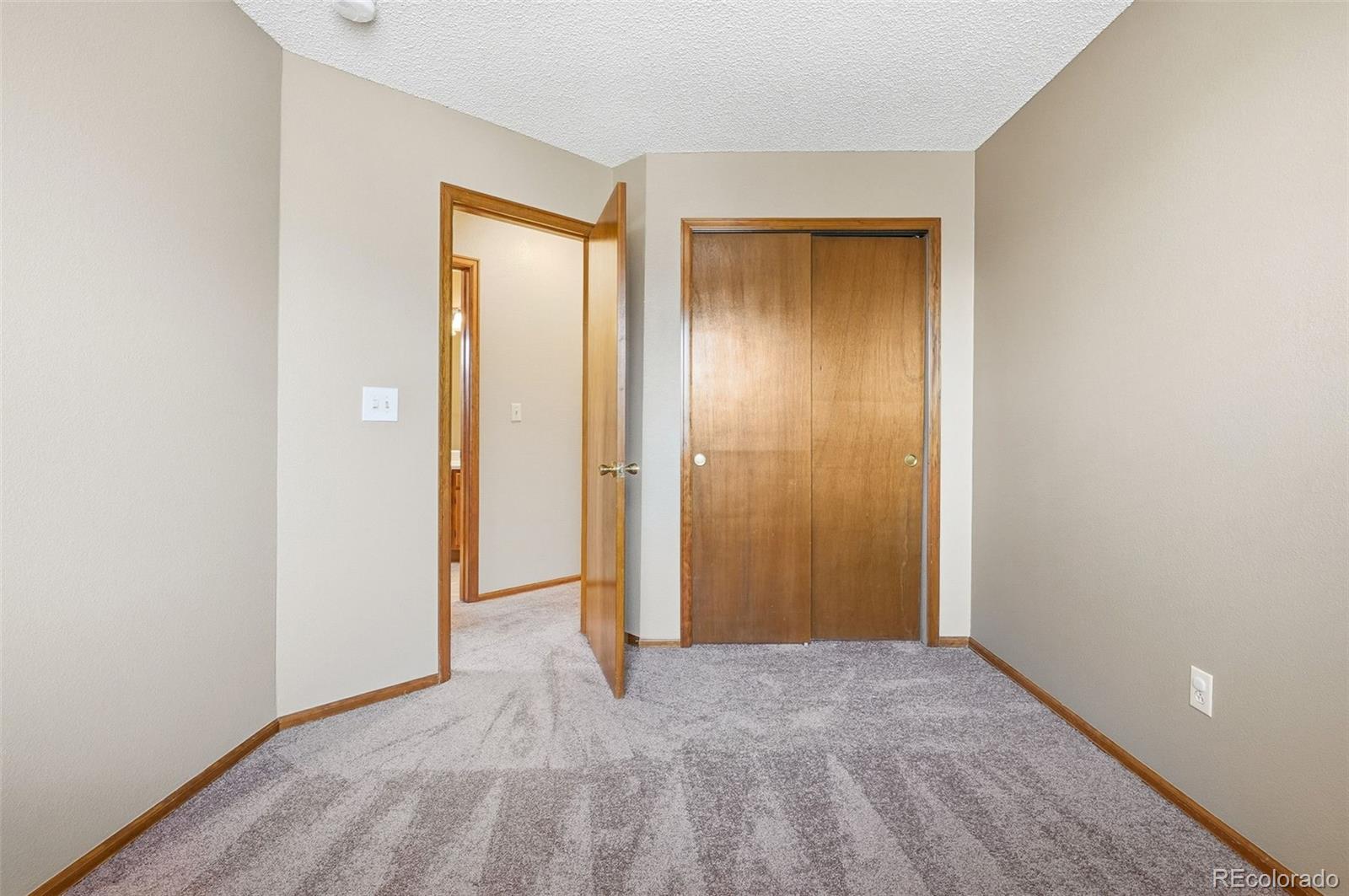 8362 Sunnyside Place Highlands Ranch, CO 80126 - Photo 32 of 50 a view of an empty room with closet and a window