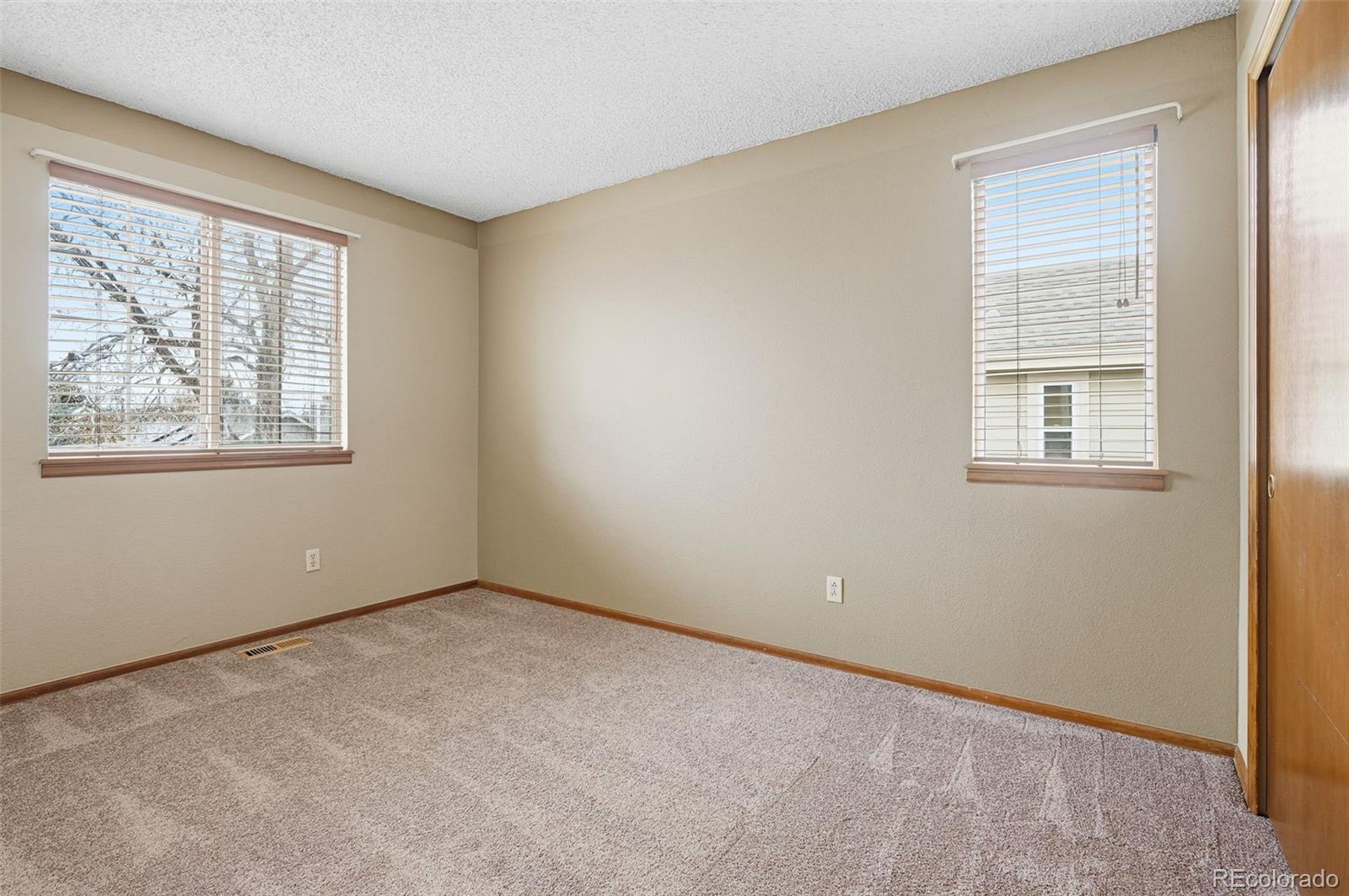 8362 Sunnyside Place Highlands Ranch, CO 80126 - Photo 33 of 50 an empty room with windows