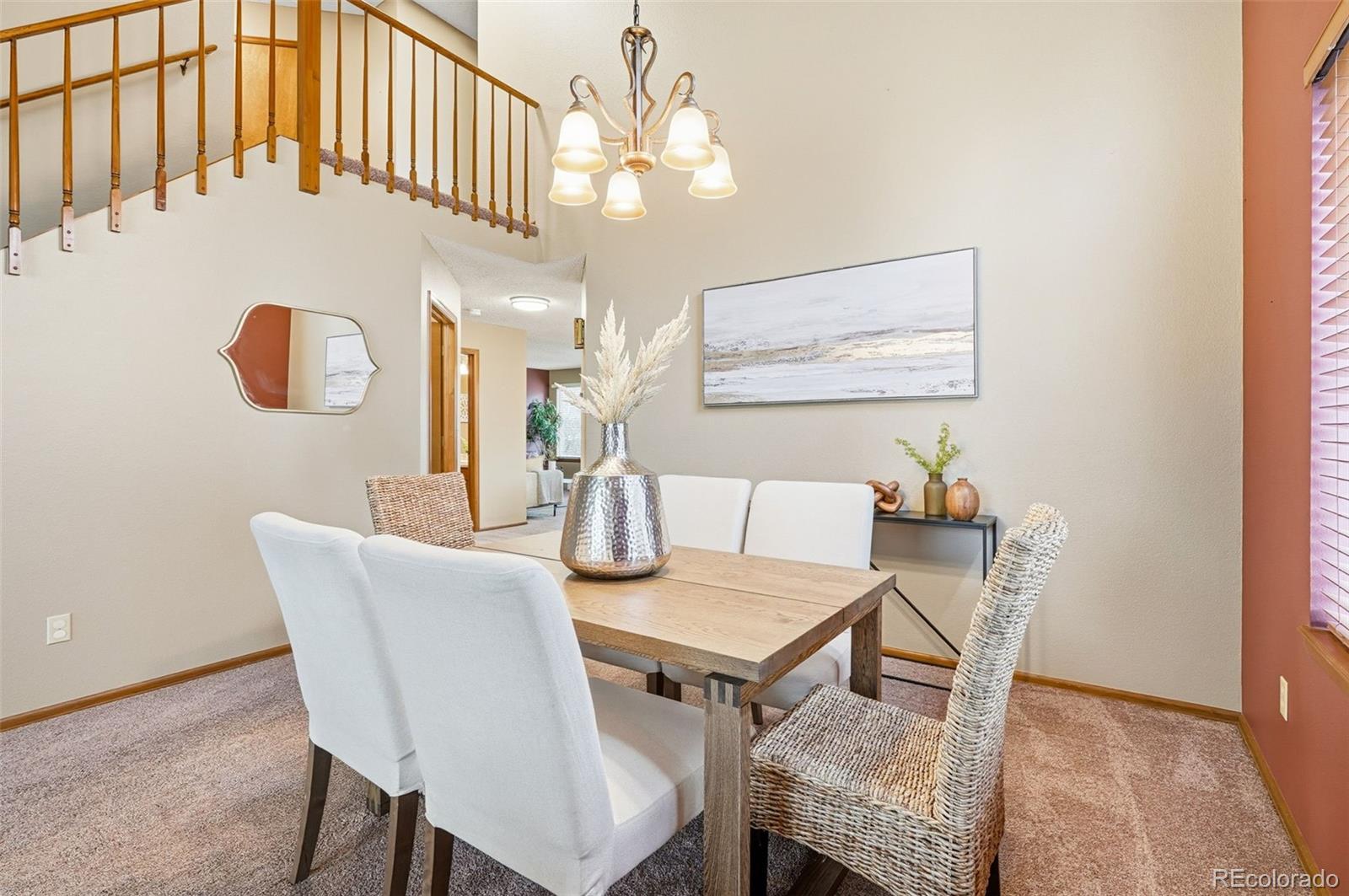8362 Sunnyside Place Highlands Ranch, CO 80126 - Photo 4 of 50 a view of a dining room with furniture and wooden floor