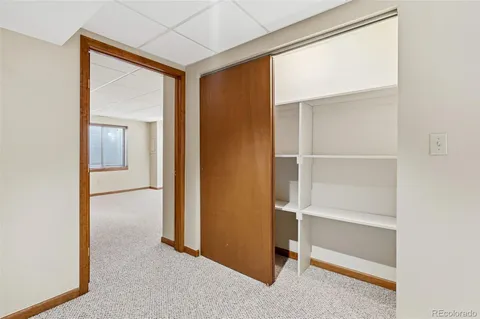 a view of a room with an empty space and a window