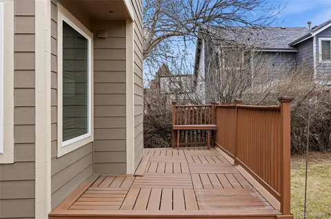 a view of a house with a yard and wooden fence