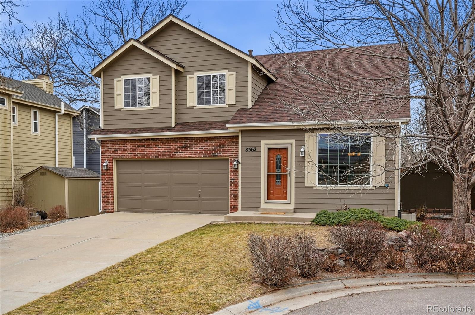 8362 Sunnyside Place Highlands Ranch, CO 80126 - Photo 8 of 50 a front view of a house with a yard and garage