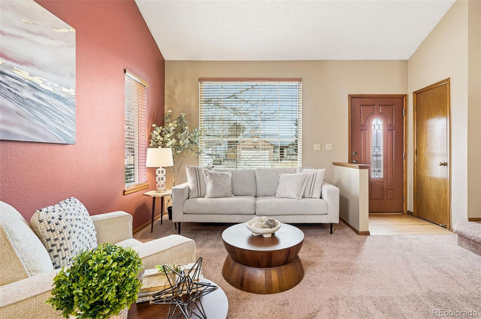 8362 Sunnyside Place Highlands Ranch, CO 80126 - Photo 9 of 50 a living room with furniture and a large window