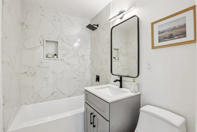 a bathroom with a sink toilet and shower