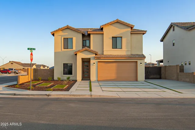 a view of a house with a small yard and plants