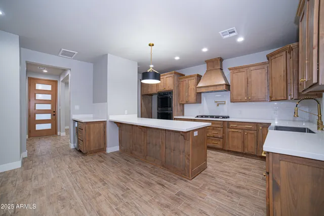 a stove top oven sitting inside of a kitchen
