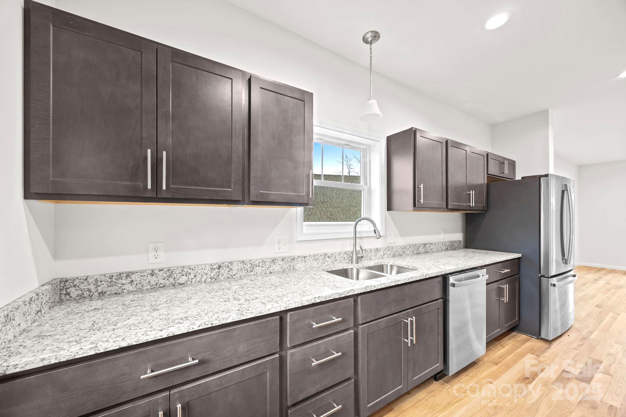 7 Berry Crest Lane Arden, NC 28704 - Photo 26 of 41 a kitchen with a sink and a refrigerator