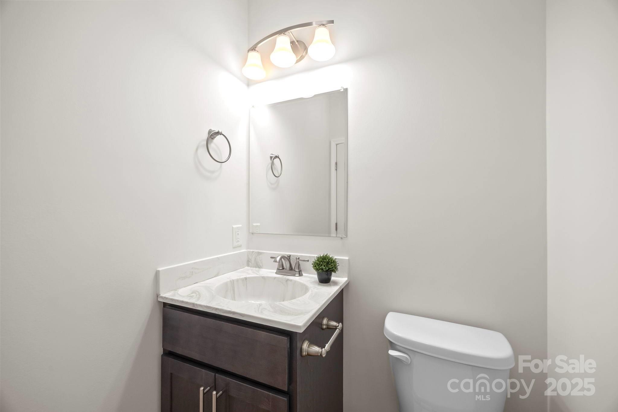 7 Berry Crest Lane Arden, NC 28704 - Photo 27 of 41 a bathroom with a sink a toilet and mirror