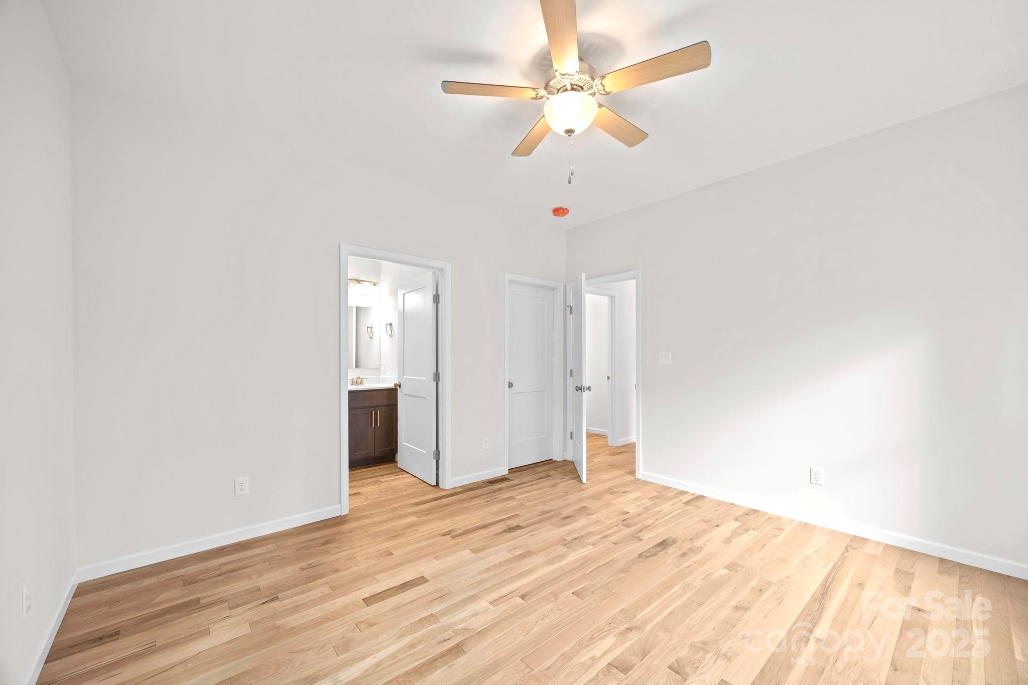 7 Berry Crest Lane Arden, NC 28704 - Photo 30 of 41 an empty room with wooden floor and fan
