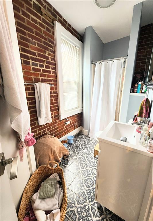 196 37th Street Pittsburgh, PA 15201 - Photo 3 of 7 a bedroom with a bed and a flat tv screen