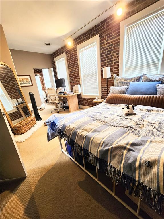 196 37th Street Pittsburgh, PA 15201 - Photo 5 of 7 a bed sitting in a bedroom next to a window